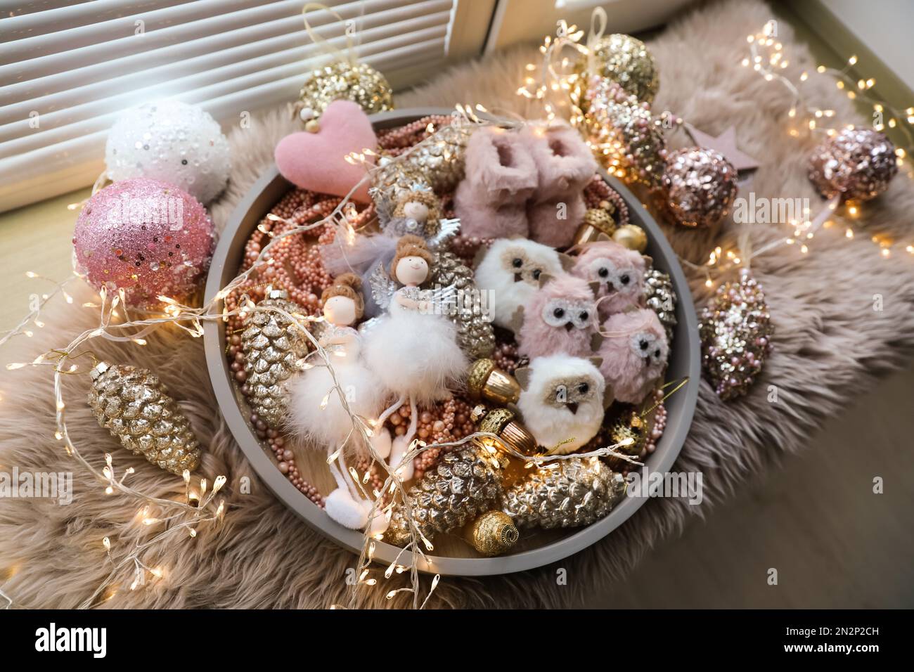 Beautiful Christmas tree baubles, toys and fairy lights on window sill, above view Stock Photo
