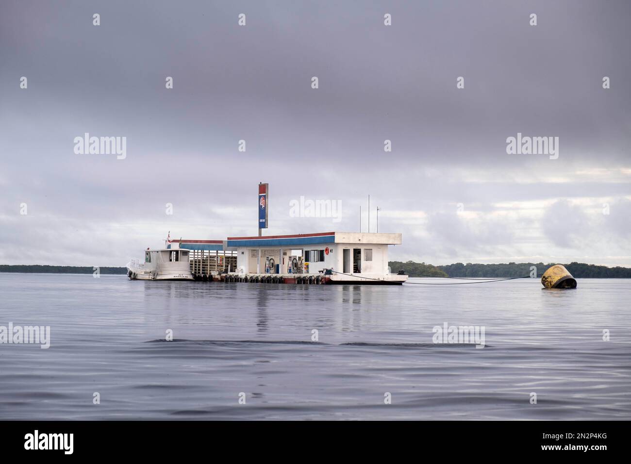 Boat refuelling at a floating river gas station near Barcelos, Brazil, Amazon, Rio Negro Basin. Central Amazon Ecological Corridor Stock Photo