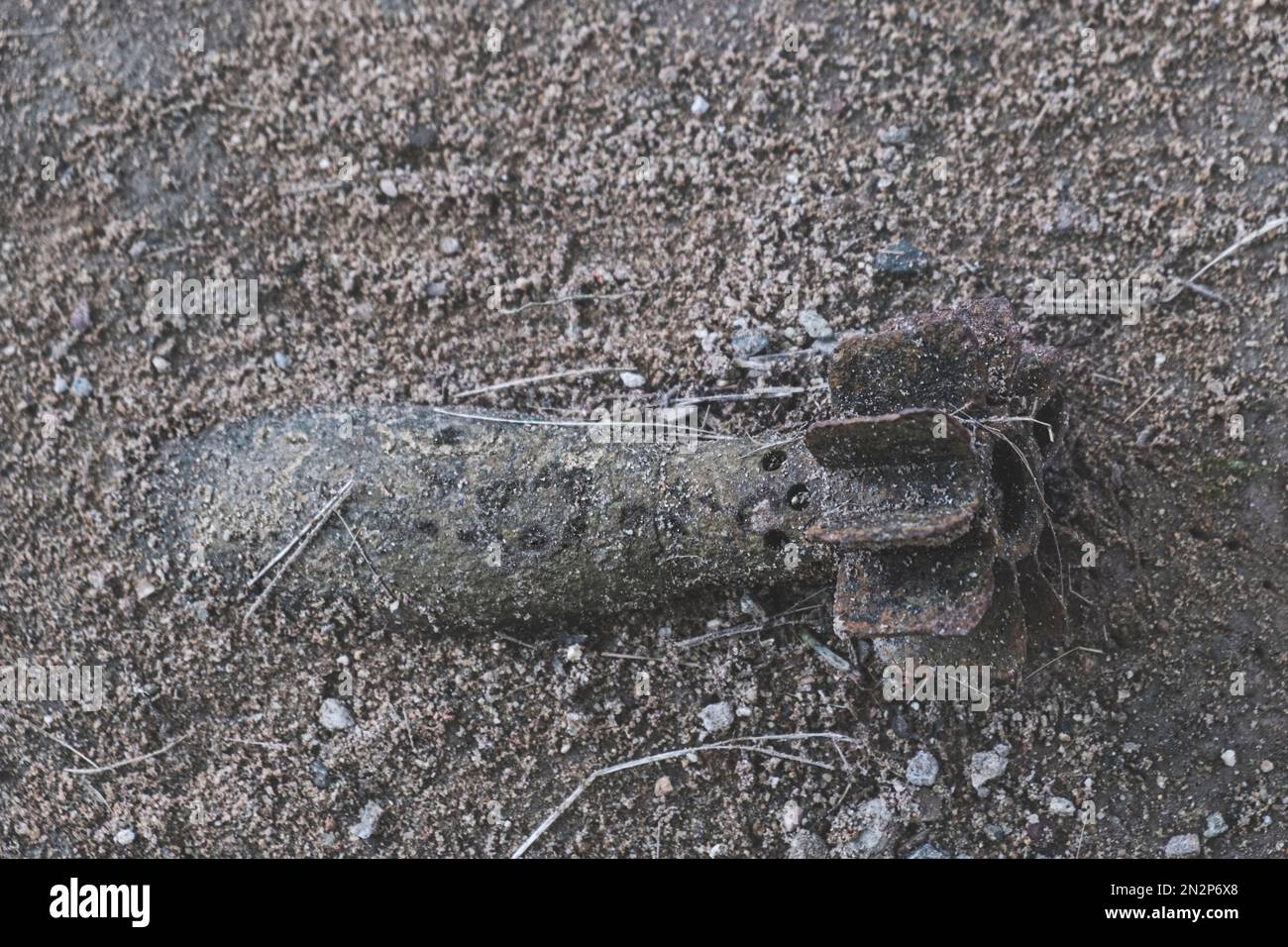 Unexploded bomb buried in a field in Cambodia - a leftover from the Khmer Rouge and Vietnam conflicts of the 20th Century Stock Photo