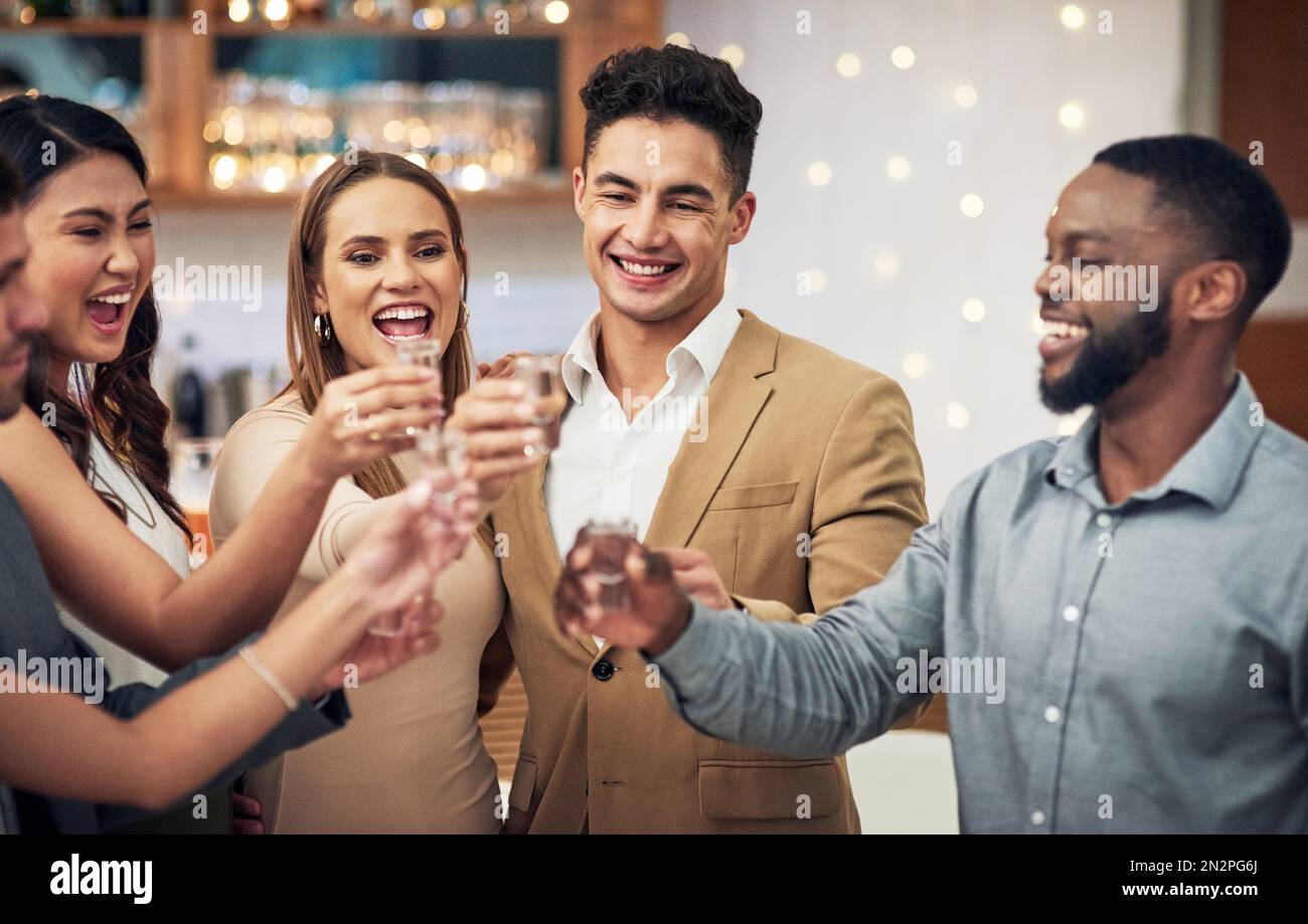 Group of friends, cheers and shots in celebration at restaurant party and happiness together for valentines day. Love, friendship and toast, happy Stock Photo