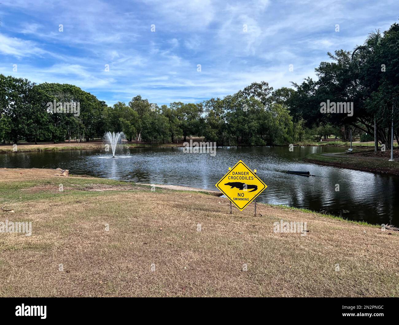 Danger Crocodiles No Swimming sign by a lake, Palmerston, Northern