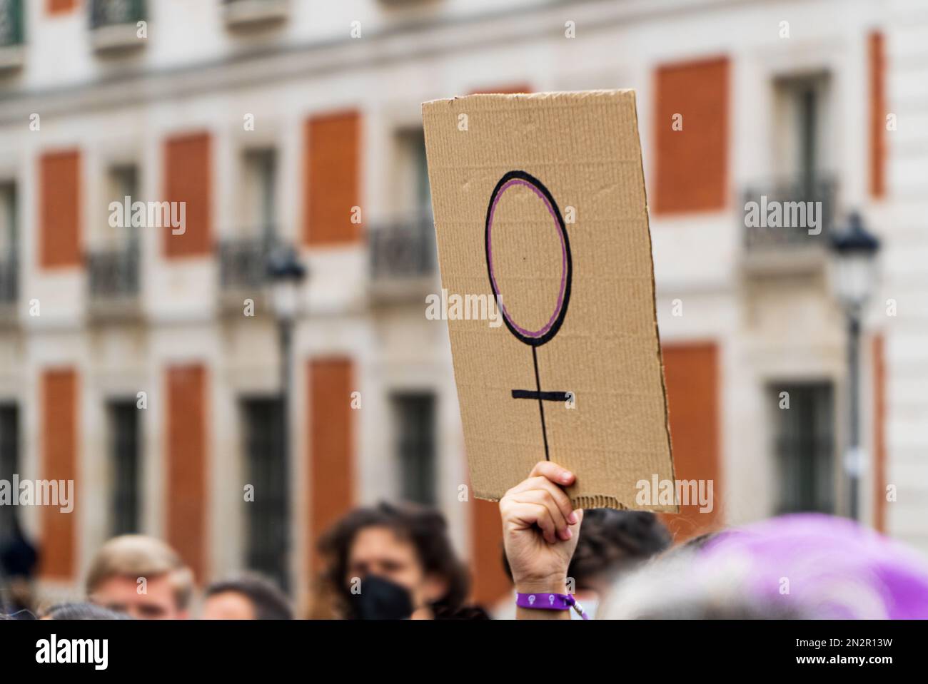Women hands supporting feminist symbol placard on 8 M demonstration Stock Photo