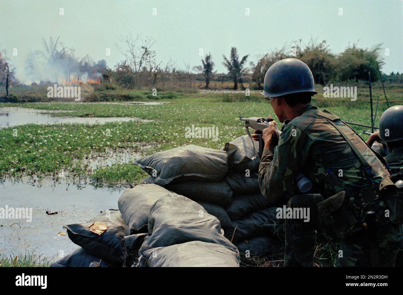 South Vietnamese Rangers fire at a suspected Viet Cong position in a ...