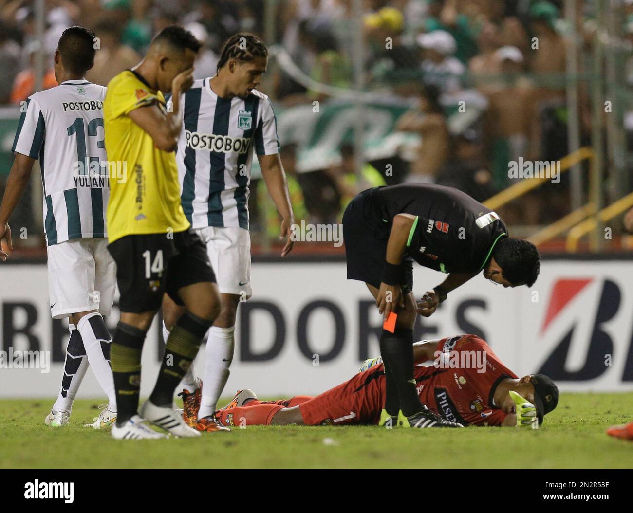 Referee Enrique Osses gives a red card to goalkeeper Maximo Banguera of