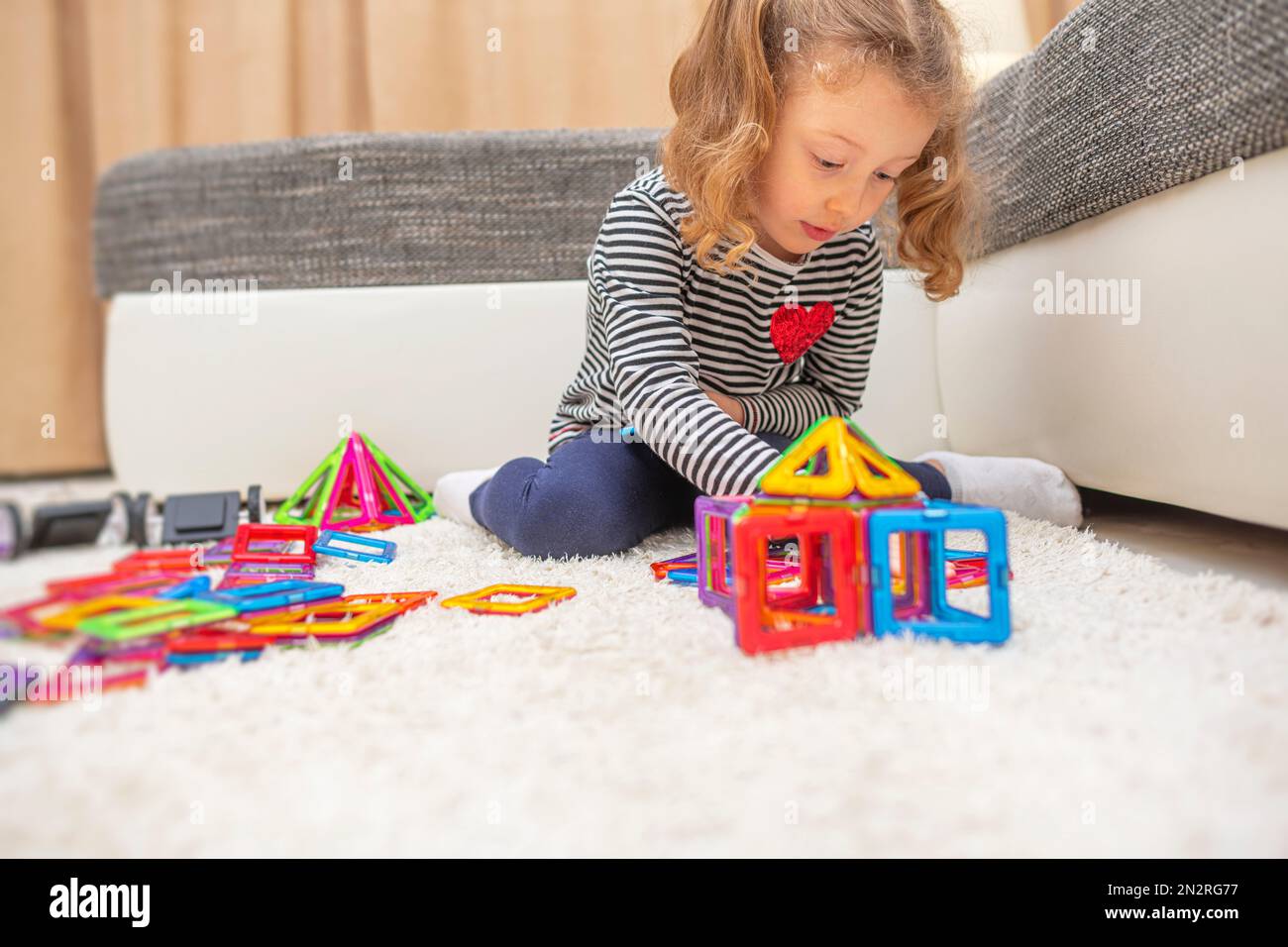 Child plays with a magnetic construction set Stock Photo - Alamy