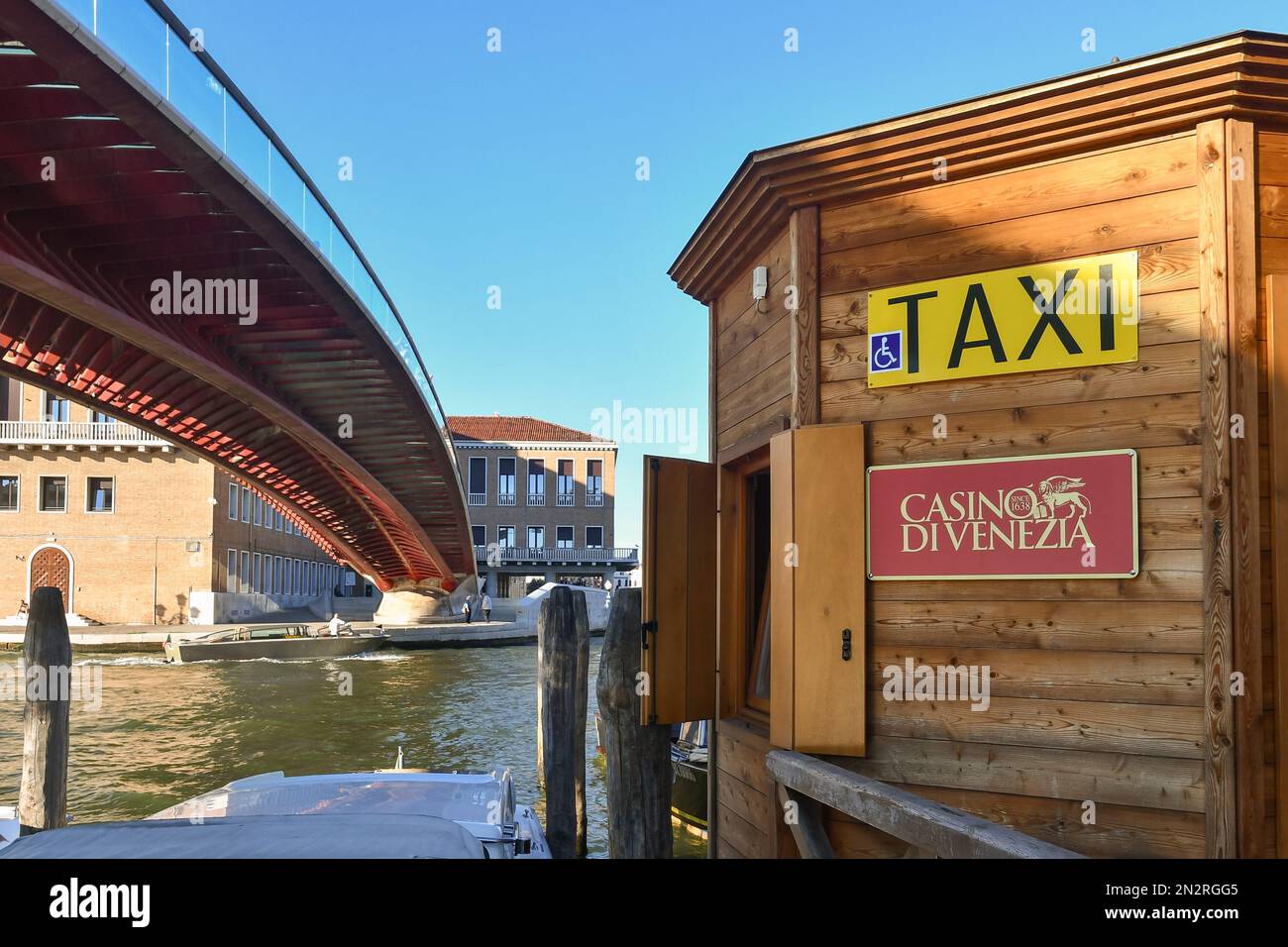 Wooden kiosk of taxi boat service with a Venice Casino sign next to the Calatrava Bridge on the Grand Canal, Venice, Veneto, Italy Stock Photo