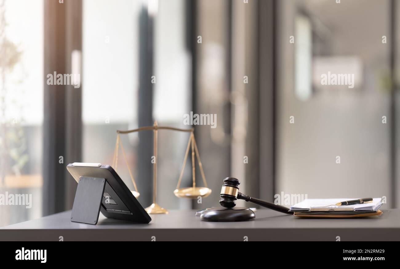 Business and lawyers discussing contract papers with brass scale on desk in office. Law, legal