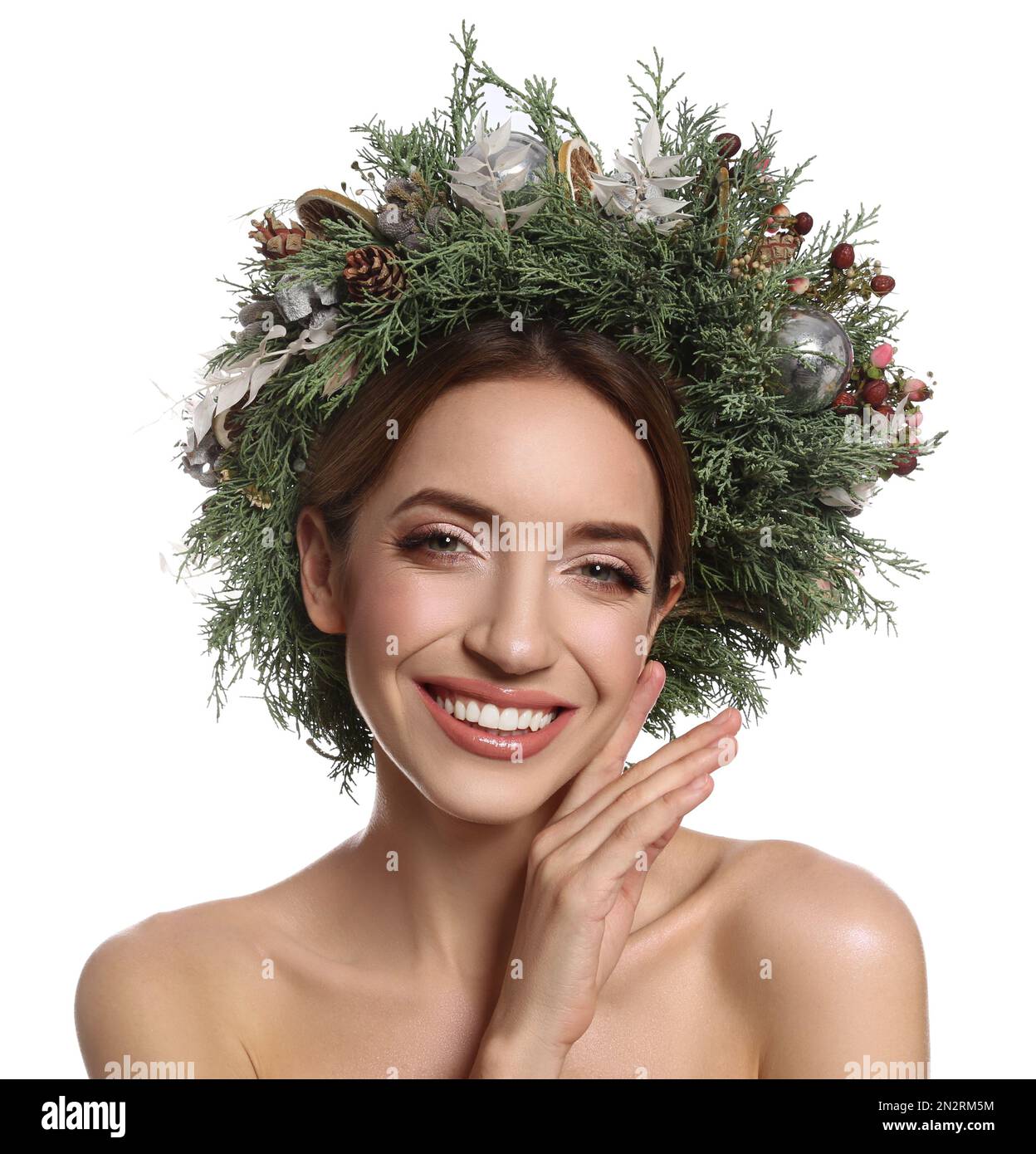 Beautiful young woman wearing Christmas wreath on white background Stock Photo