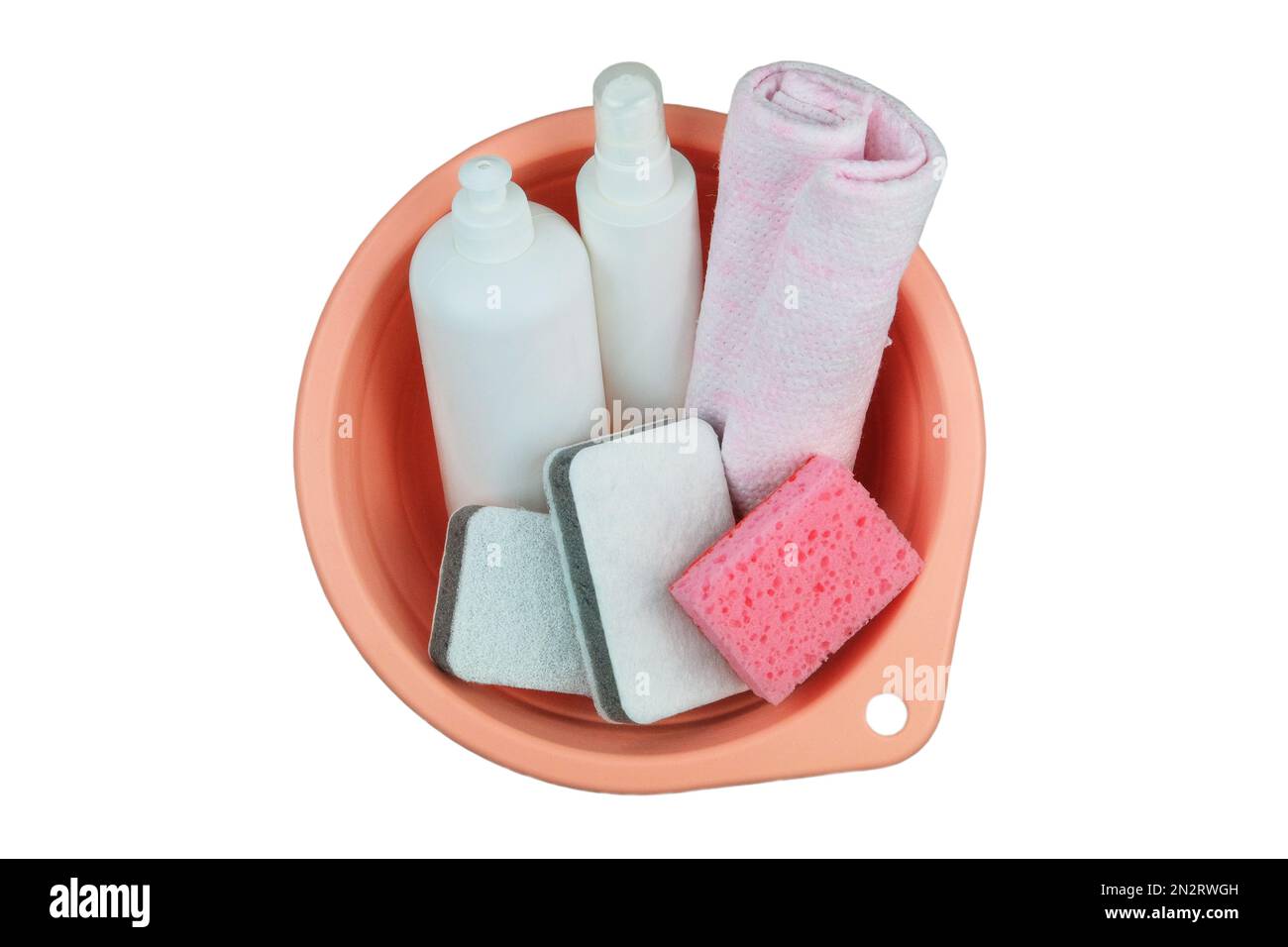 Detergent bottles with washcloths in a pink basin. Isolate on a white background. Top view. Stock Photo
