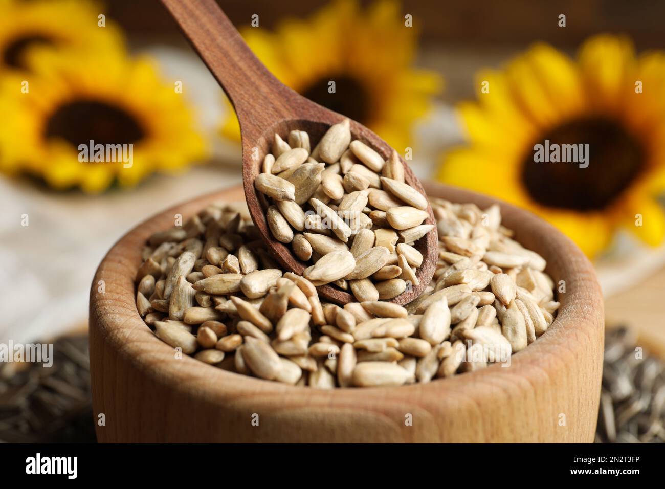 Raw peeled sunflower seeds in wooden bowl, closeup Stock Photo - Alamy