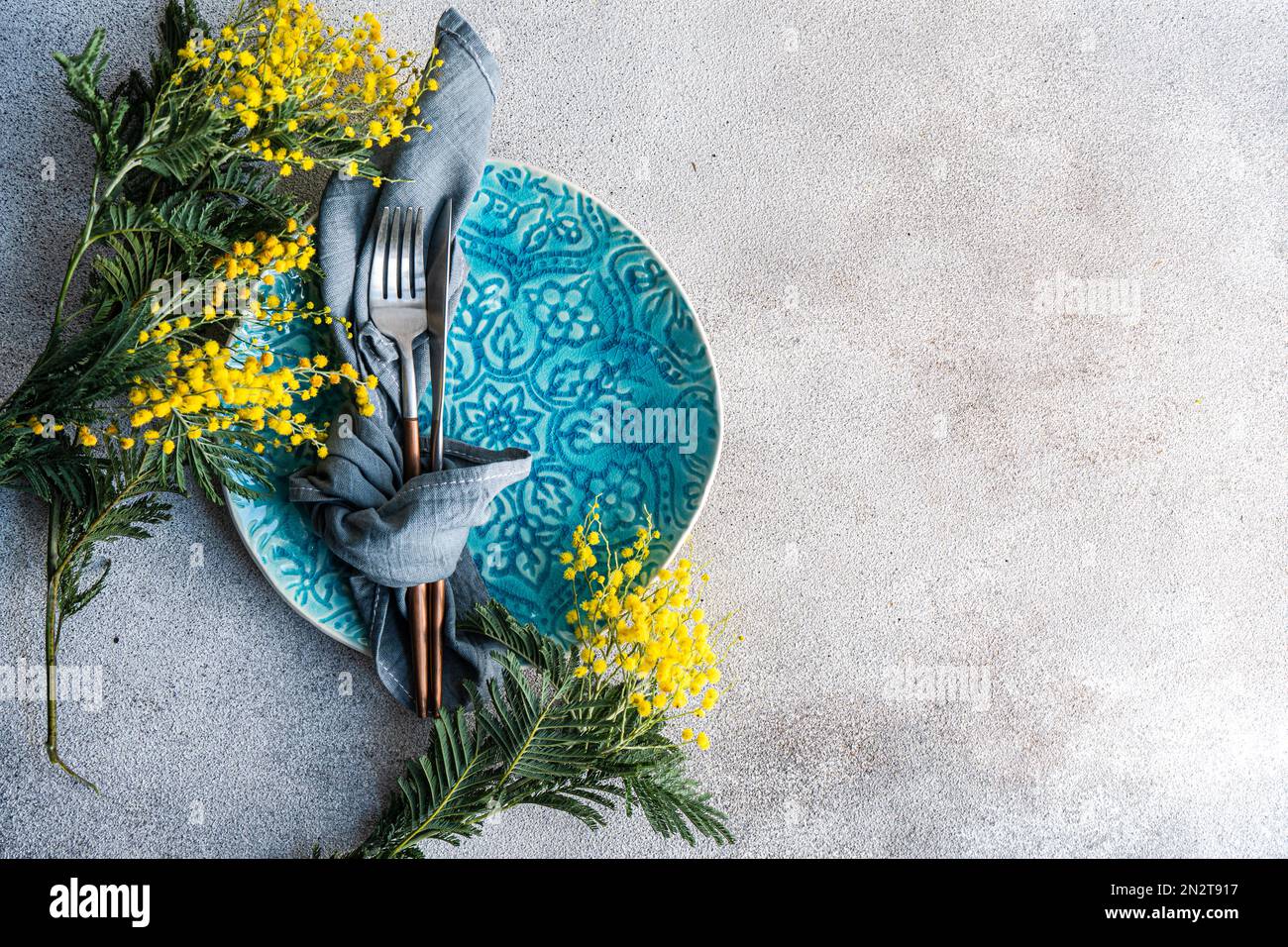 Table setting for Easter dinner with mimosa Stock Photo