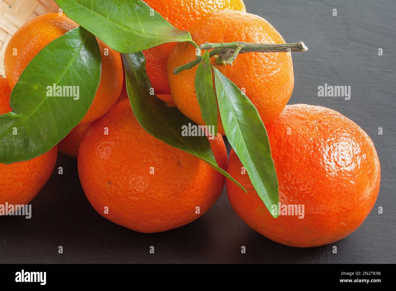 Clementines and their leaves on a dark background Stock Photo Alamy