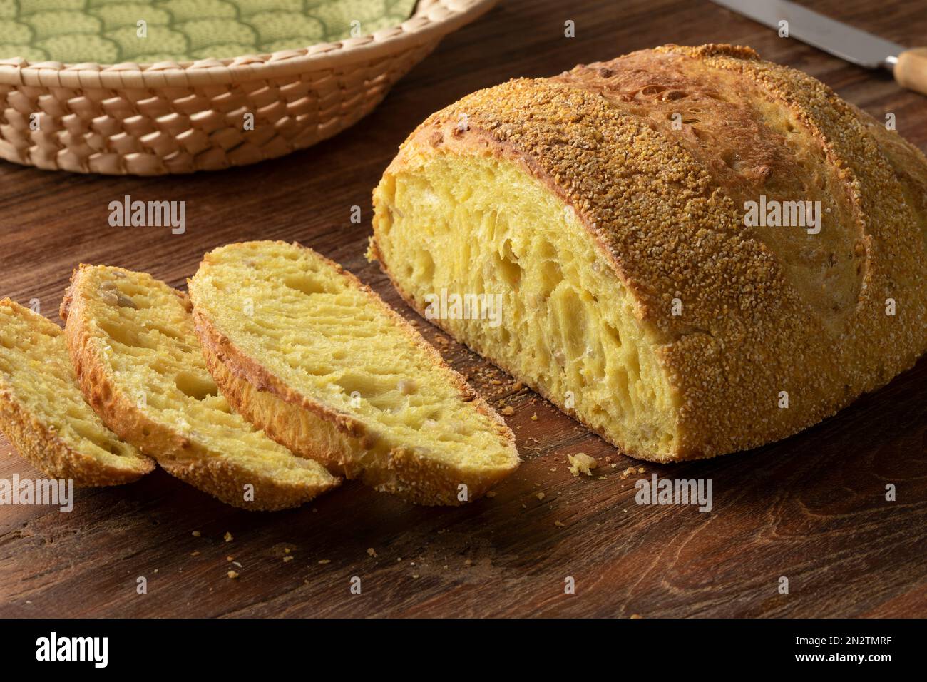 Fresh baked corn bread loaf and slices on a cutting board close up Stock Photo