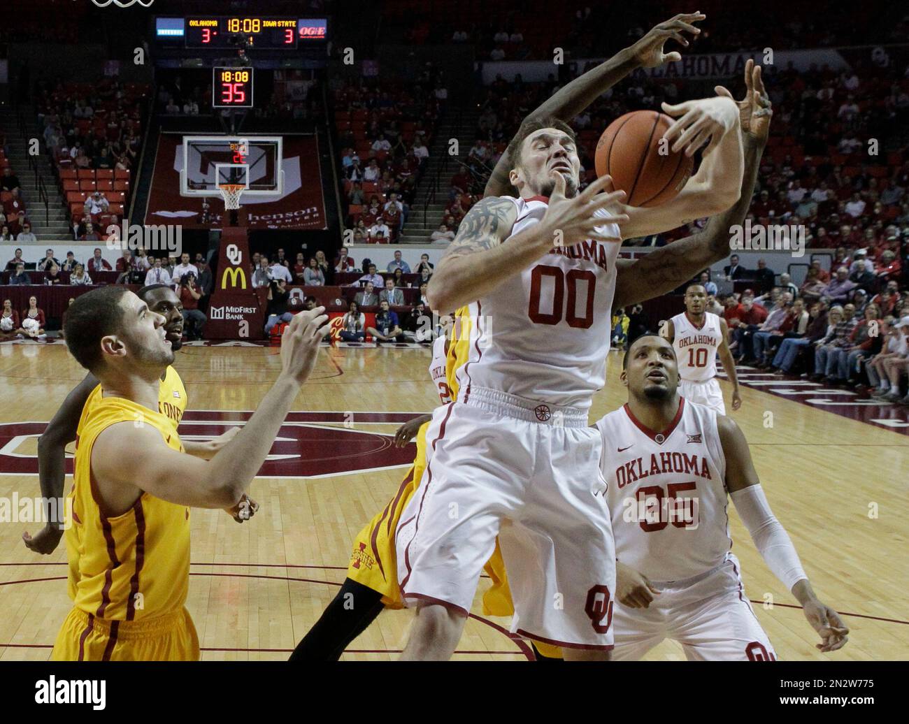 Oklahoma forward Ryan Spangler (0) grabs a rebound in front of Iowa