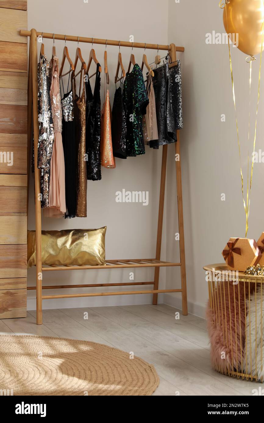 Rack with stylish women's clothes in room. Interior design Stock Photo ...