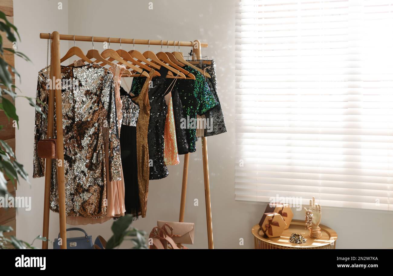 Rack with stylish women's clothes in room. Interior design Stock Photo ...