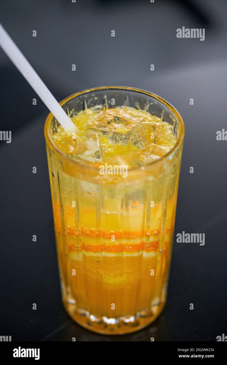 A cup of refreshing orange sparkling water drink in summer Stock Photo