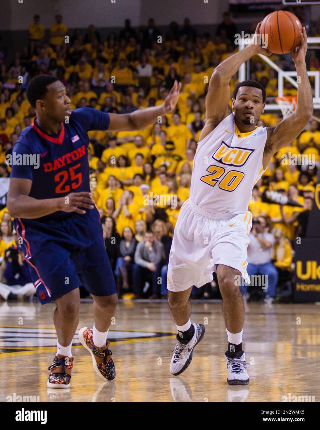 VCU guard Jordan Burgess, right, throws a pass as Dayton forward