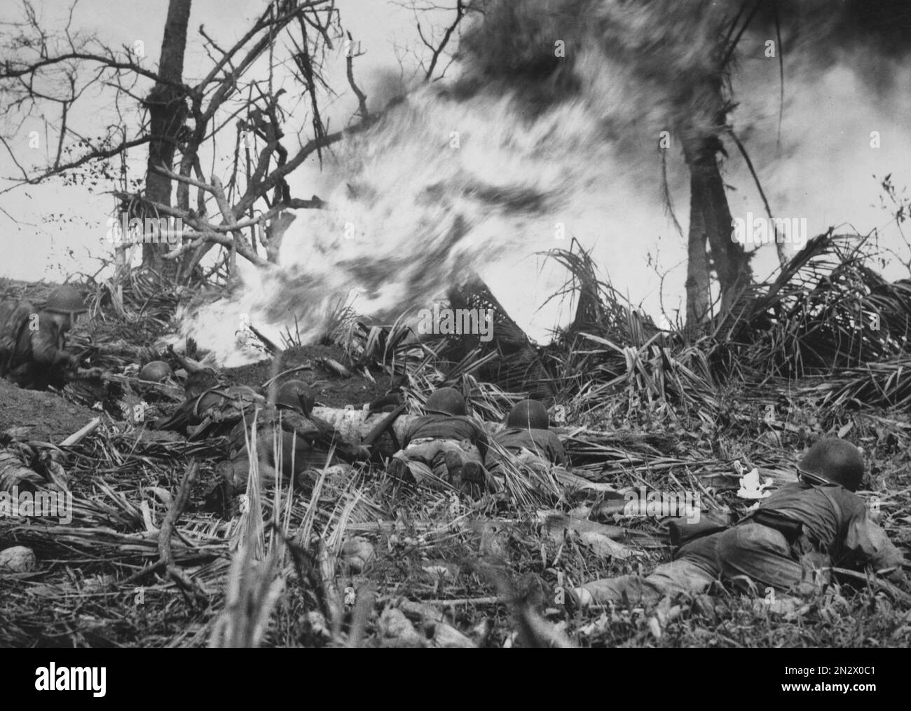 GUAM, MARIANA ISLANDS - August / September 1944 - US Marines use a flamethrower on a Japanese bunker during the Second Battle of Guam in the Mariana I Stock Photo