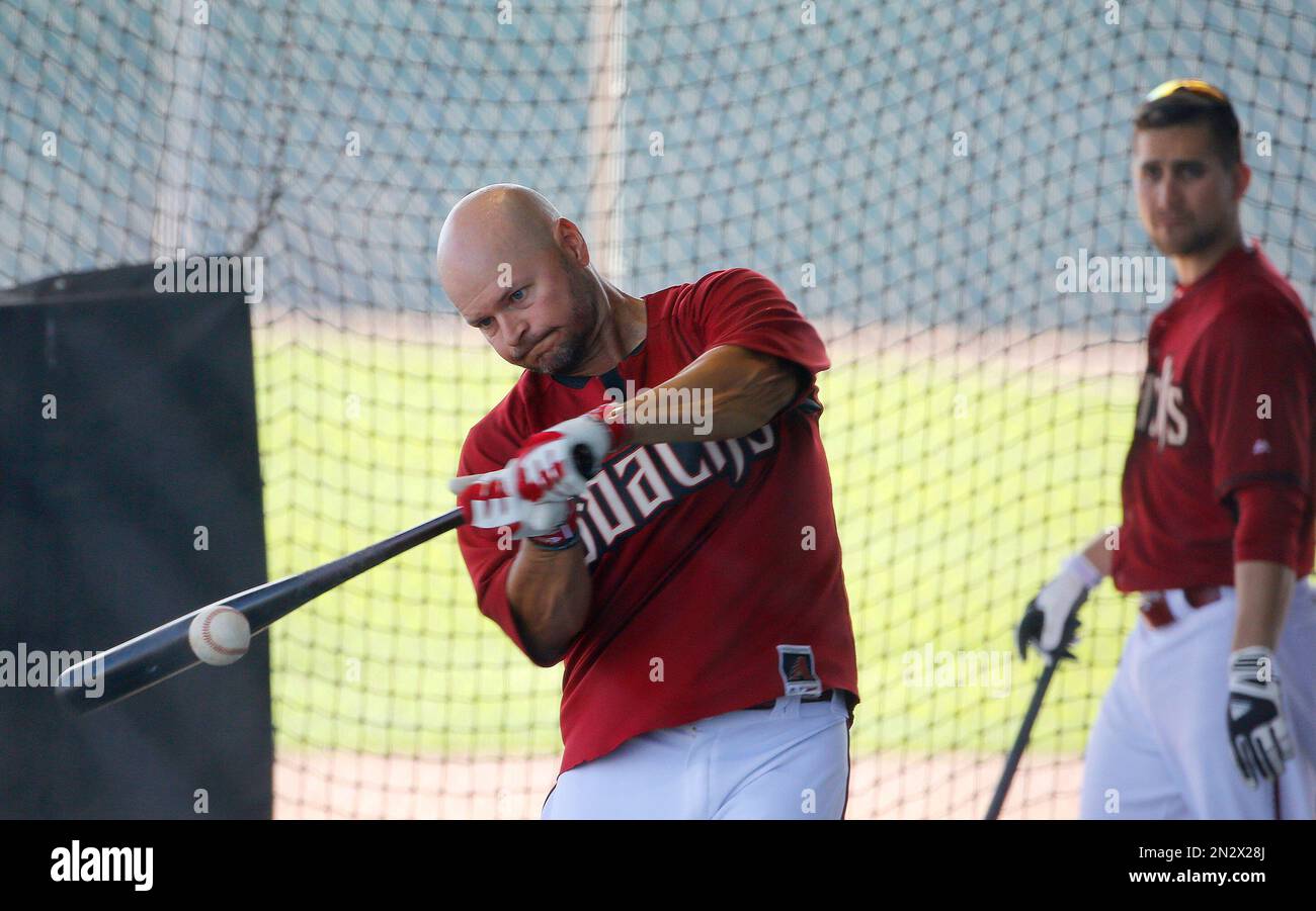 Arizona Diamondbacks' Cody Ross, left, connects on a baseball as
