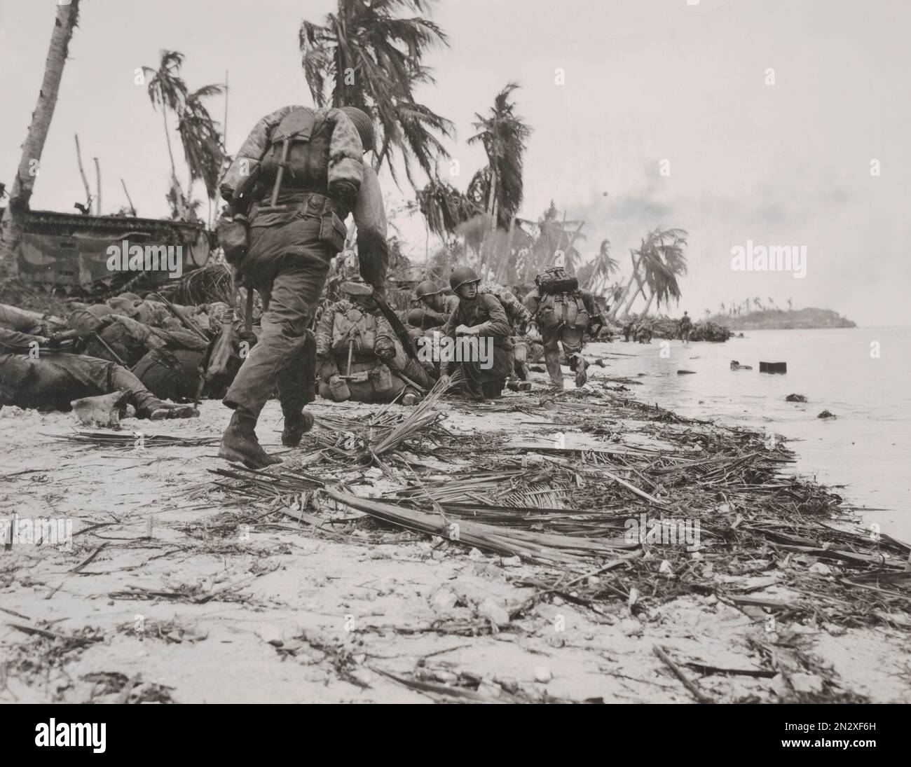 GUAM, MARIANA ISLANDS - 21 July 1944 - US Marines take cover while coming under fire from Japanese defenders during the Second Battle of Guam in the M Stock Photo