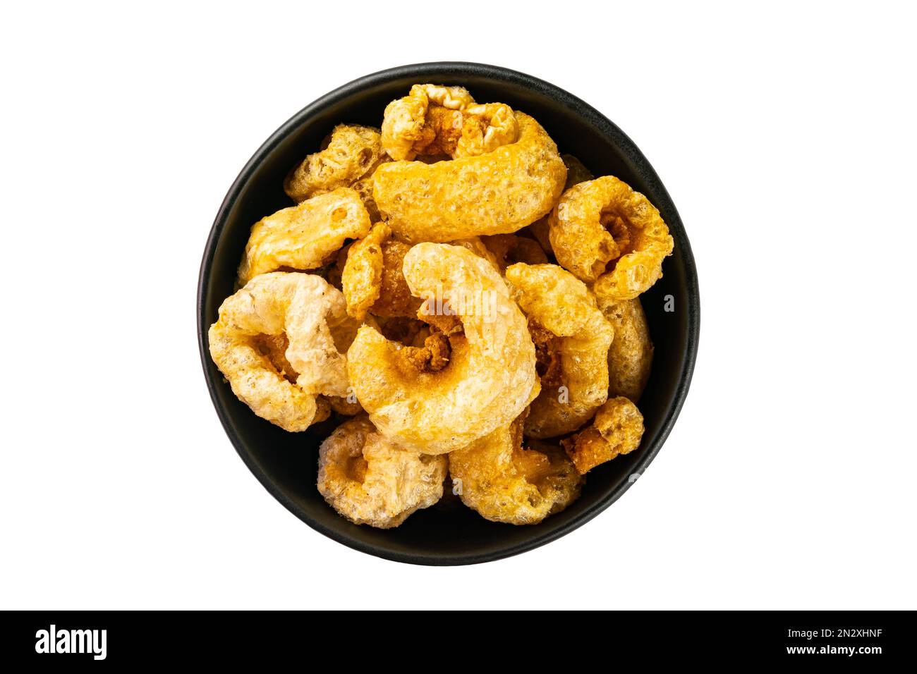 Top view of homemade crispy delicious deep fried pork rinds in black
