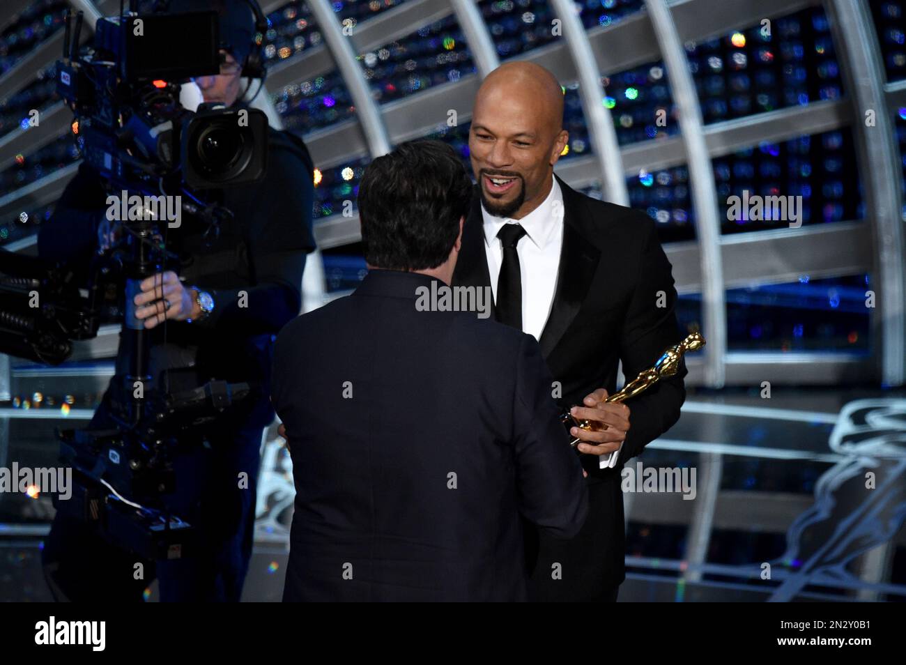 John Travolta, left, presents Common with the award for best original