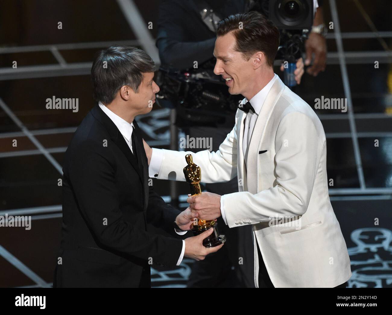 Benedict Cumberbatch, right, presents Tom Cross with the award for best
