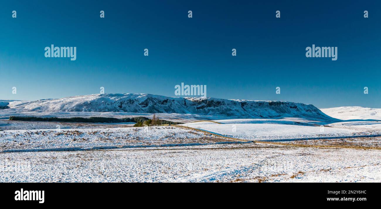 Cronkley Scar made even more dramatic by a covering of snow under a cloudless deep blue sky. Stock Photo