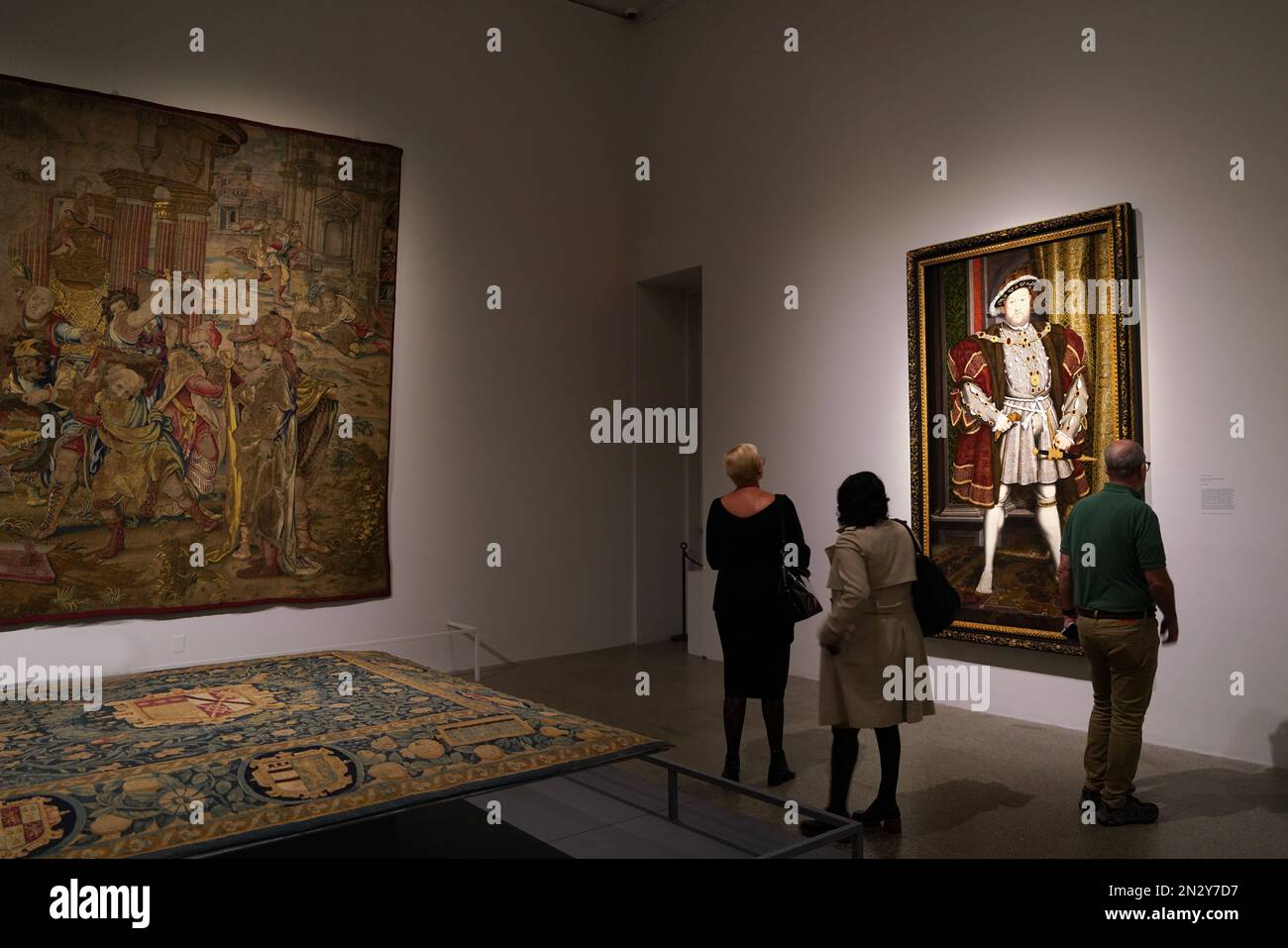 New York, NY - October 2022:  Visitors to the Met's Tudor Gallery admire a full length portrait of King Henry VIII, by Hans Holbein, circa 1540. Stock Photo