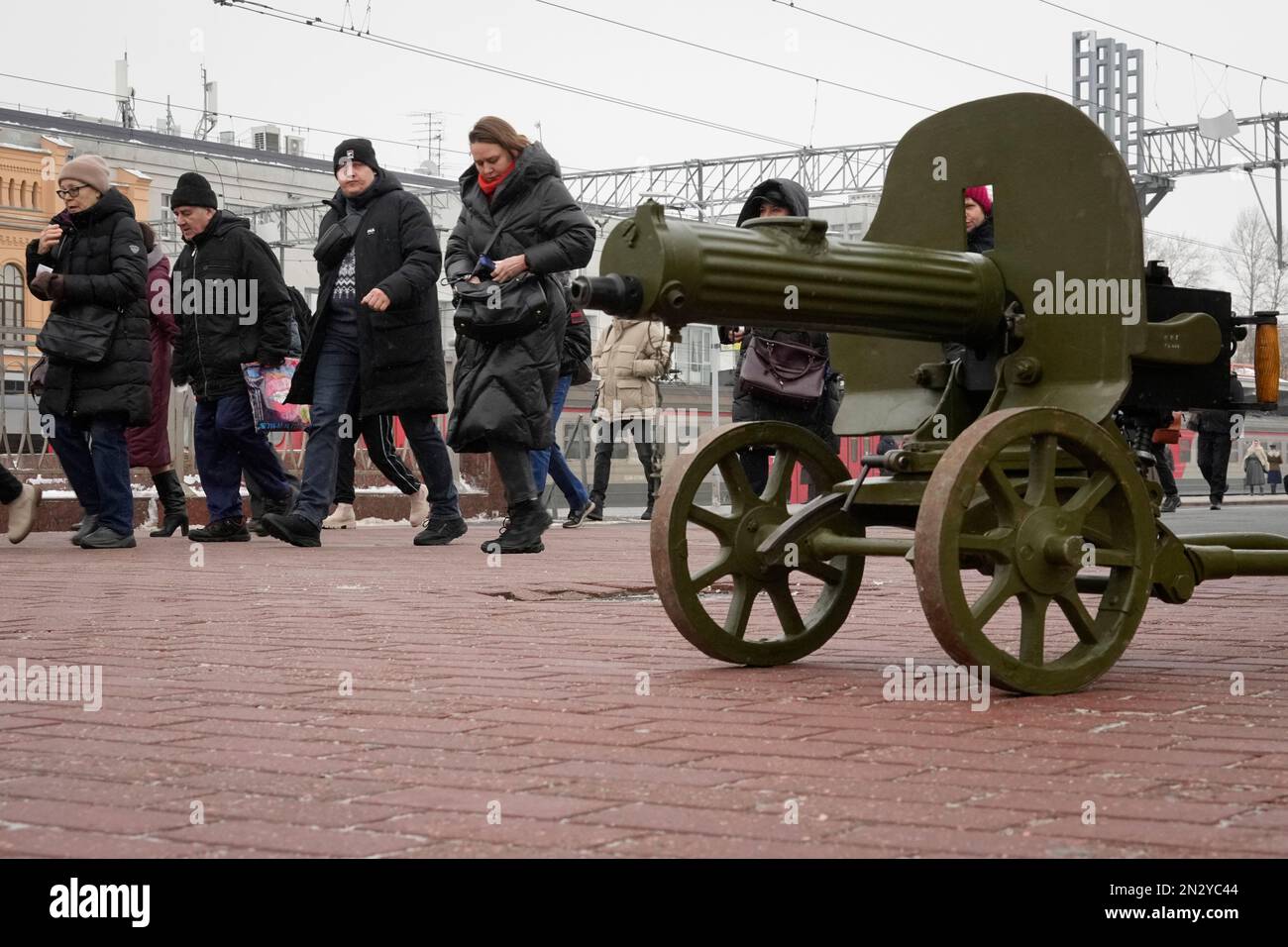 People Walk Along The Railway Platform Past A World War II-era Machine ...