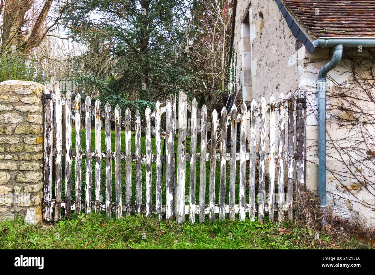 Country cottage wooden garden gates in need of repainting - France. Stock Photo
