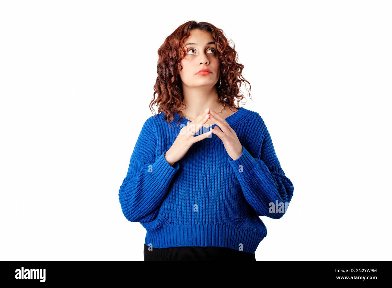 Cute woman standing isolated over white background cunningly touching fingertips together