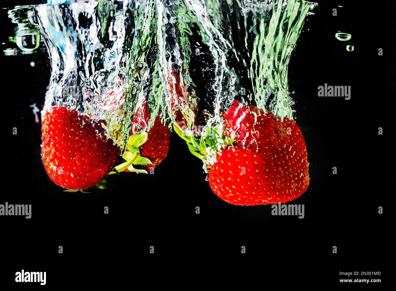 Strawberries cherries splash water hi-res stock photography and images ...