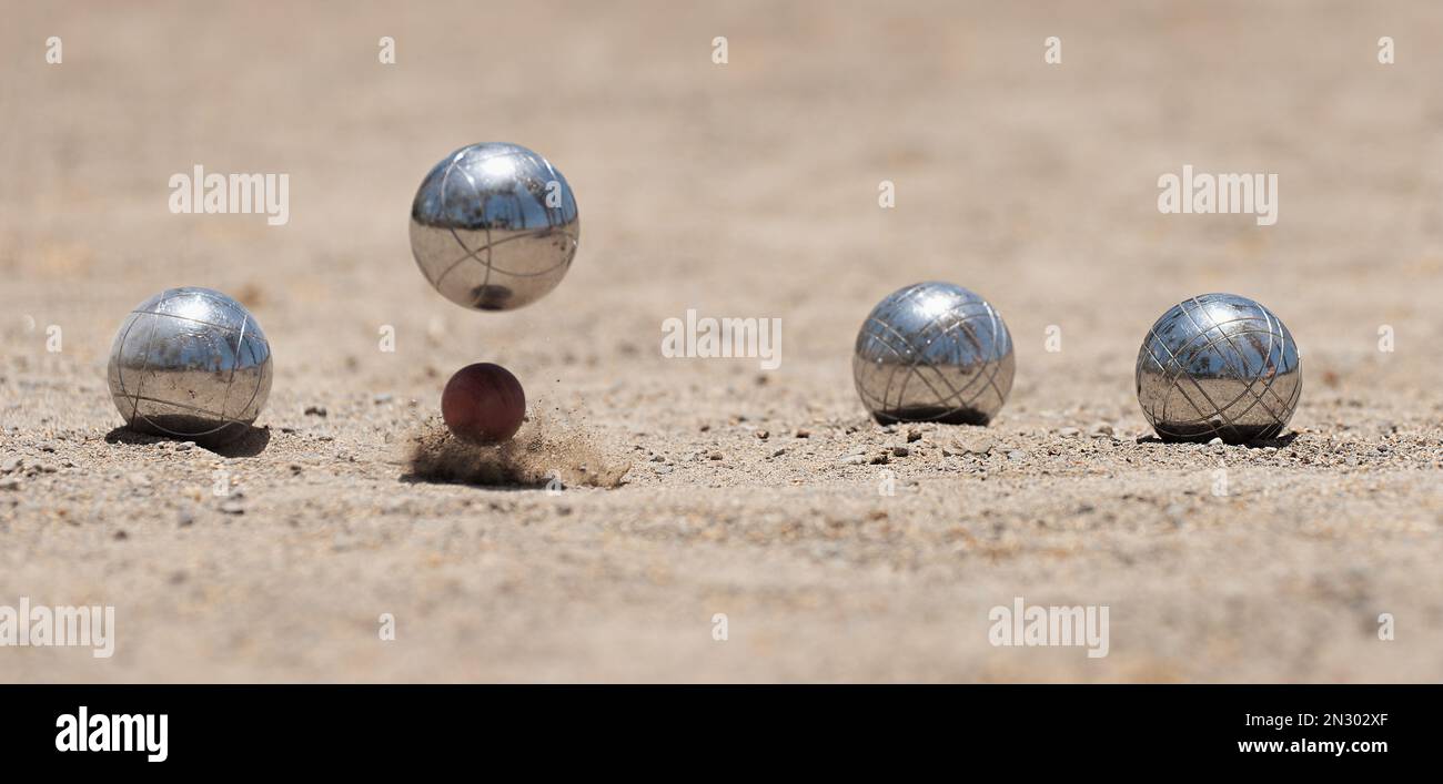 Petanque ball boules bowls on a dust floor, photo in impact. Balls and