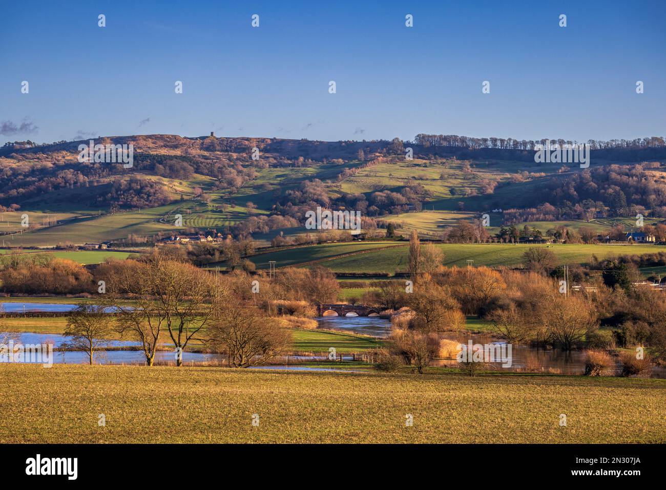 Bredon Hill Tower and Eckington Bridge over the River Avon in the Cotswolds AONB, Worcestershire, England Stock Photo