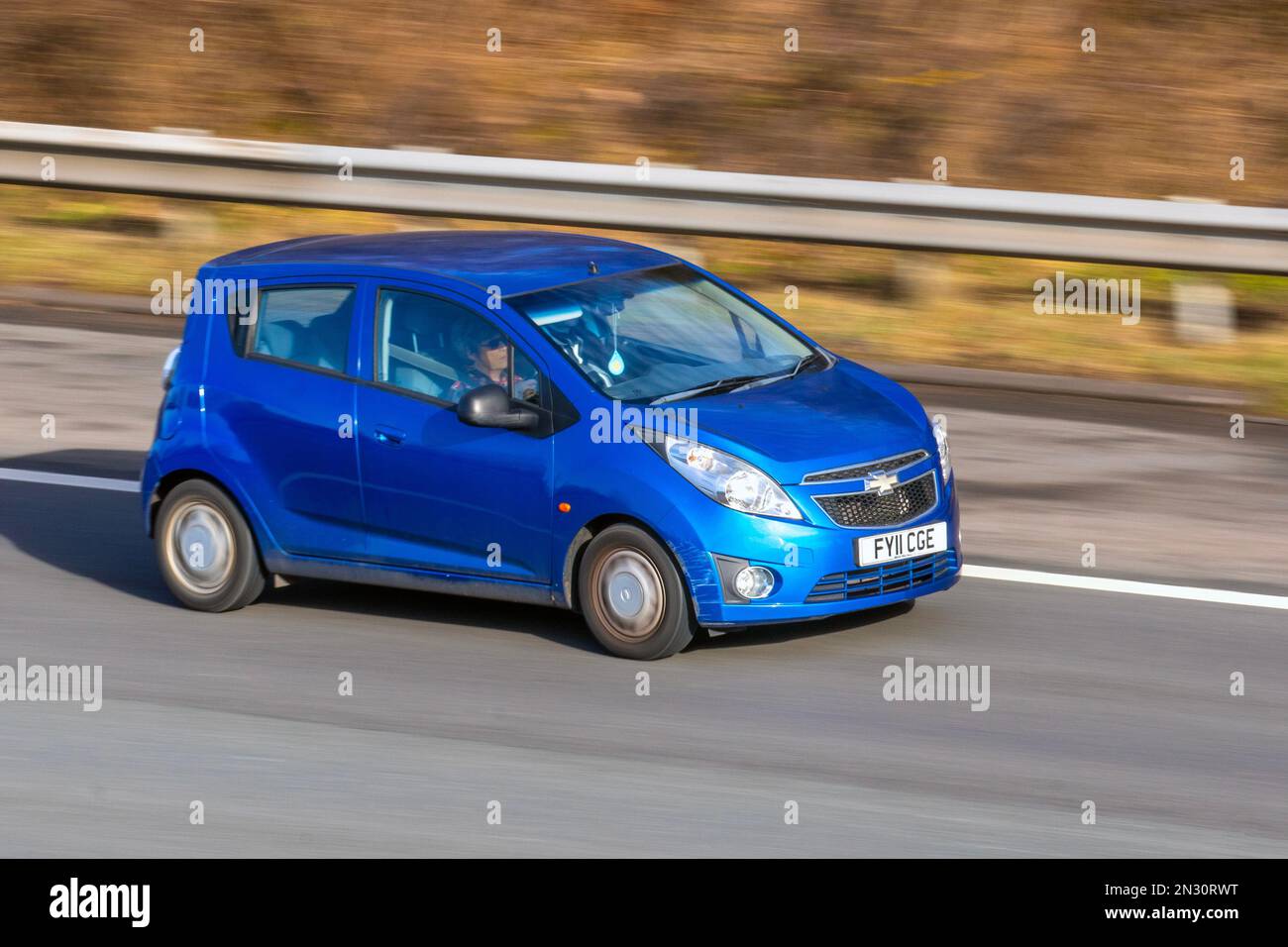 2011 Blue CHEVROLET Chevvy, SPARK 1206cc small 5 speed manual two door family car; travelling on the M61 motorway UK Stock Photo