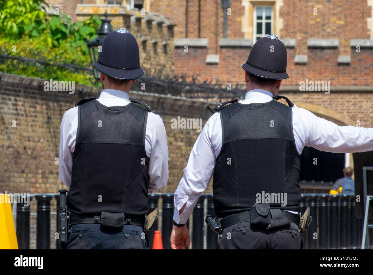 London bobbies. English policemen from behind in a street of London UK Stock Photo