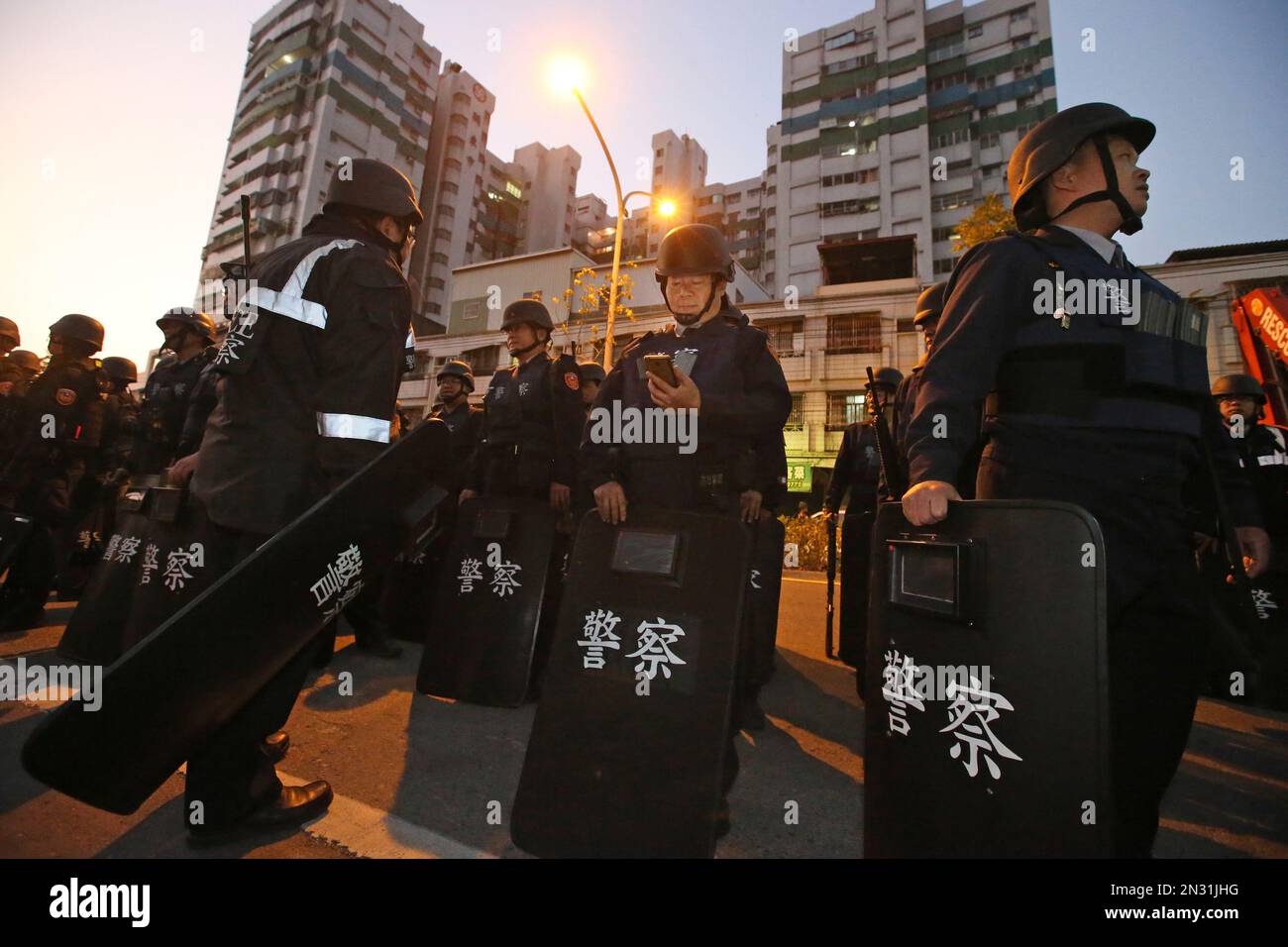 Police in riot gear gather outside of a prison as prisoners hold prison ...
