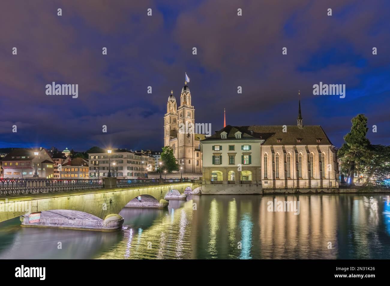 Zurich Switzerland, night city skyline at Grossmunster Church and Munster Bridge Stock Photo