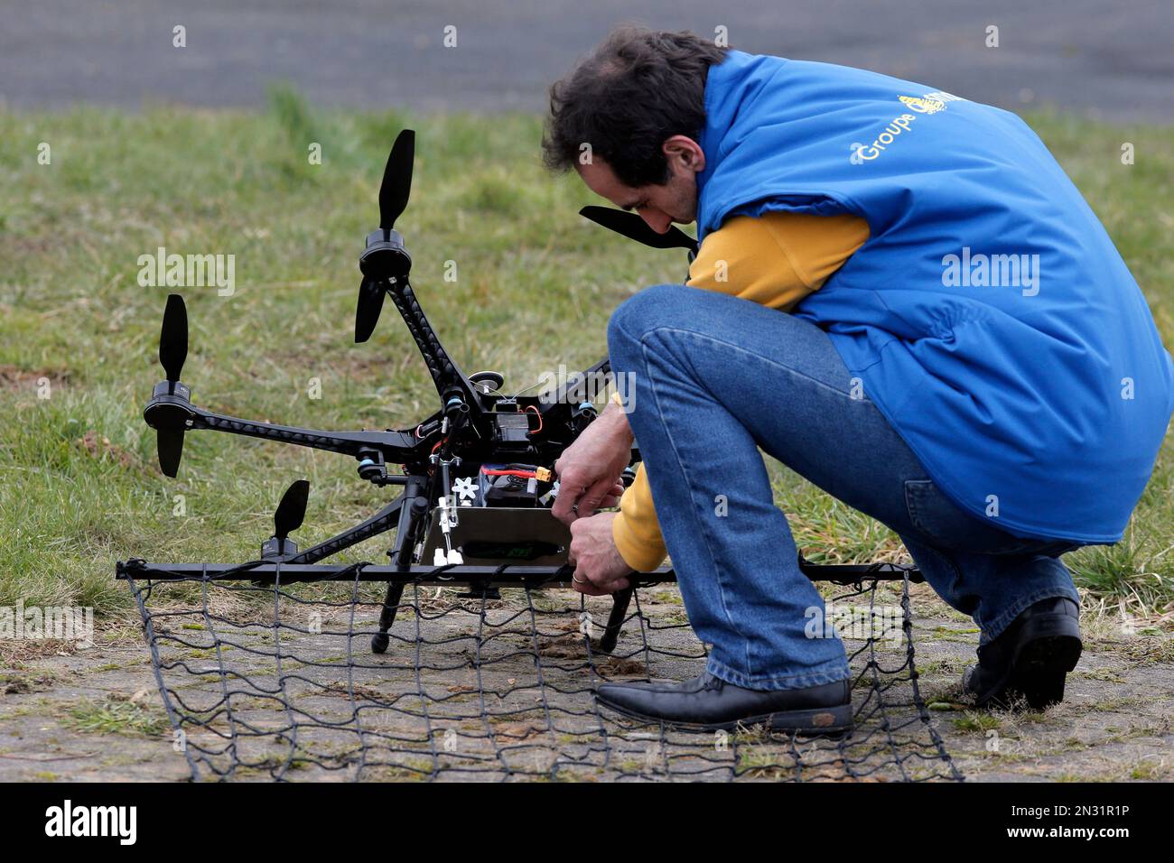 French company Malou Tech pilot Philippe Dardini prepares a drone  Interceptor MP200 during a demonstration flight in La Queue-en-Brie, east  of Paris, France, Monday, Feb. 9, 2015. For months, France has faced
