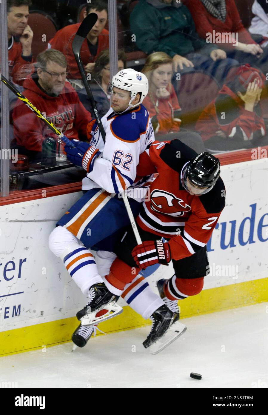 New Jersey Devils defenseman Marek Zidlicky (2), of the Czech Republic,  checks Edmonton Oilers right wing Iiro Pakarinen (62), of Finland, during  the third period of an NHL hockey game Monday, Feb.