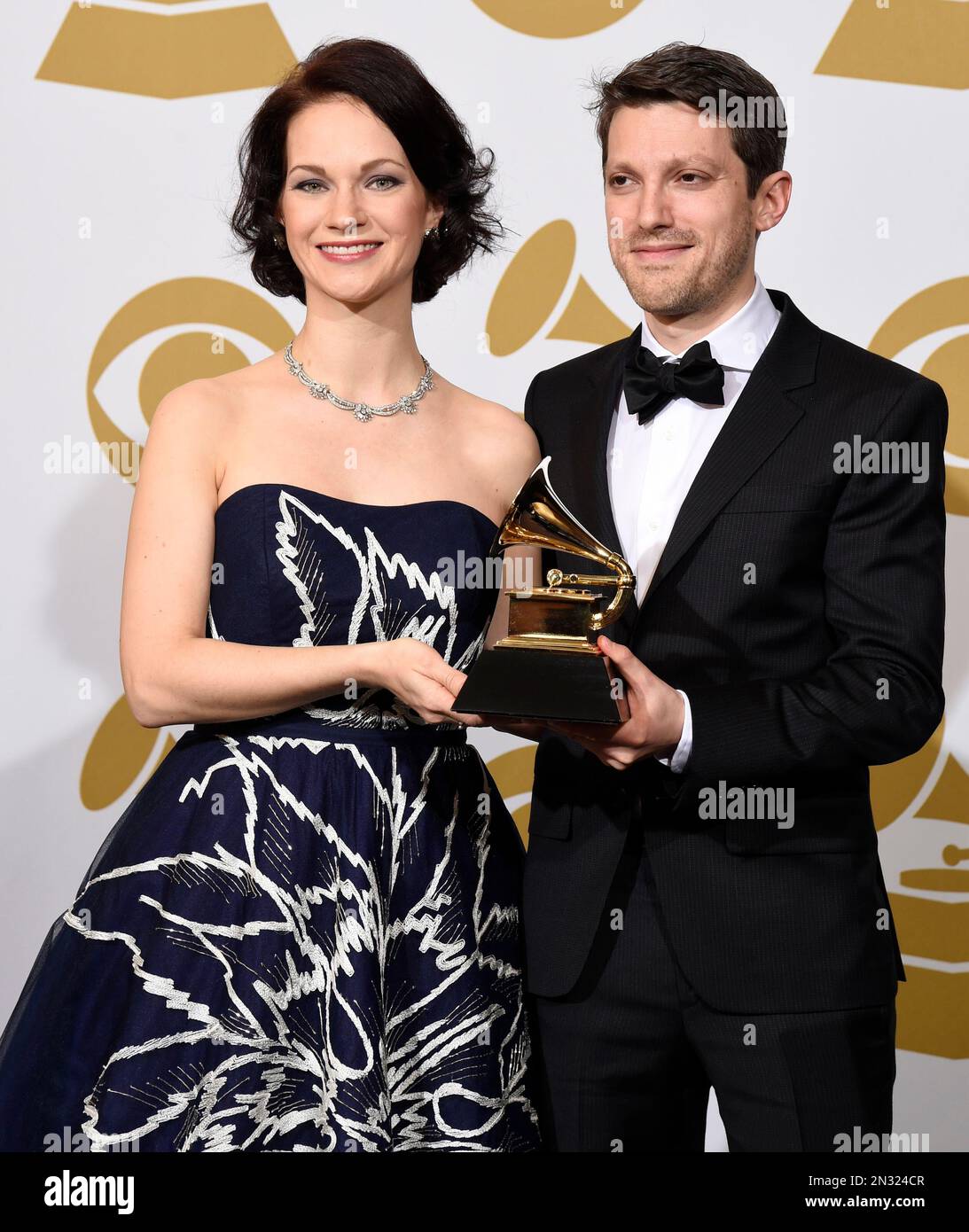 Hilary Hahn, left, and Cory Smythe pose in the press room with the award  for best chamber music/small ensemble performance for “In 27 Pieces - The  Hilary Hahn Encores” at the 57th