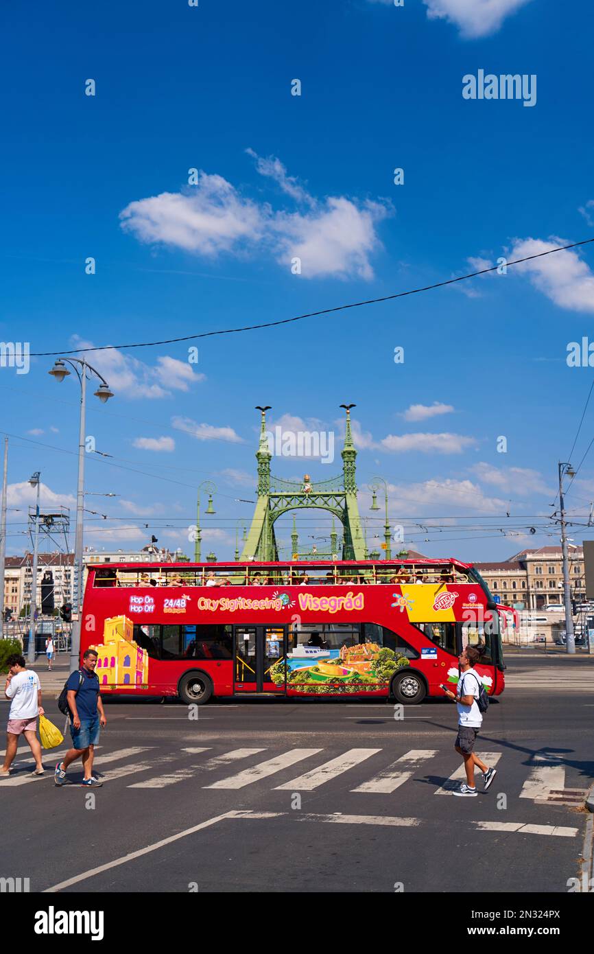 A doubledecker tourist bus transports tourists through the streets of the city. Budapest, Hungary - 08.25.2022 Stock Photo