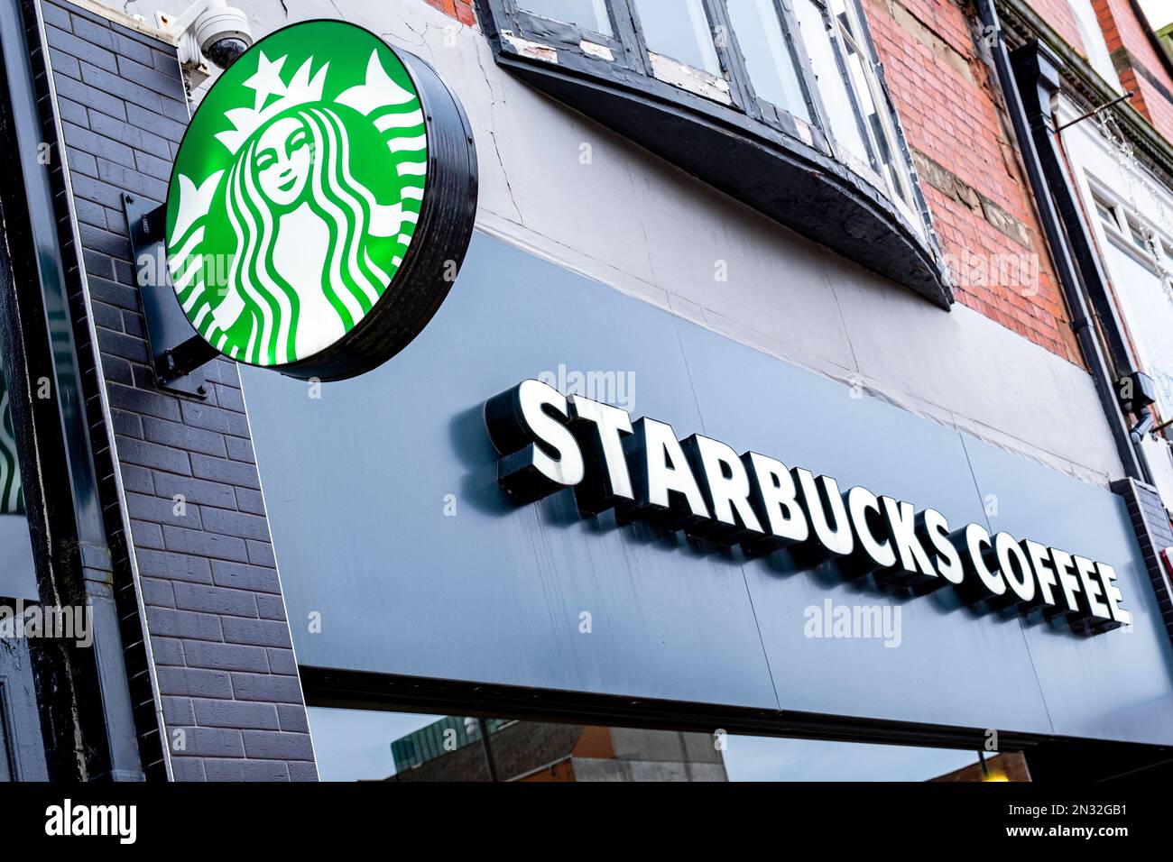 Close up of Starbucks Coffee sign with logo on outside wall UK Stock Photo