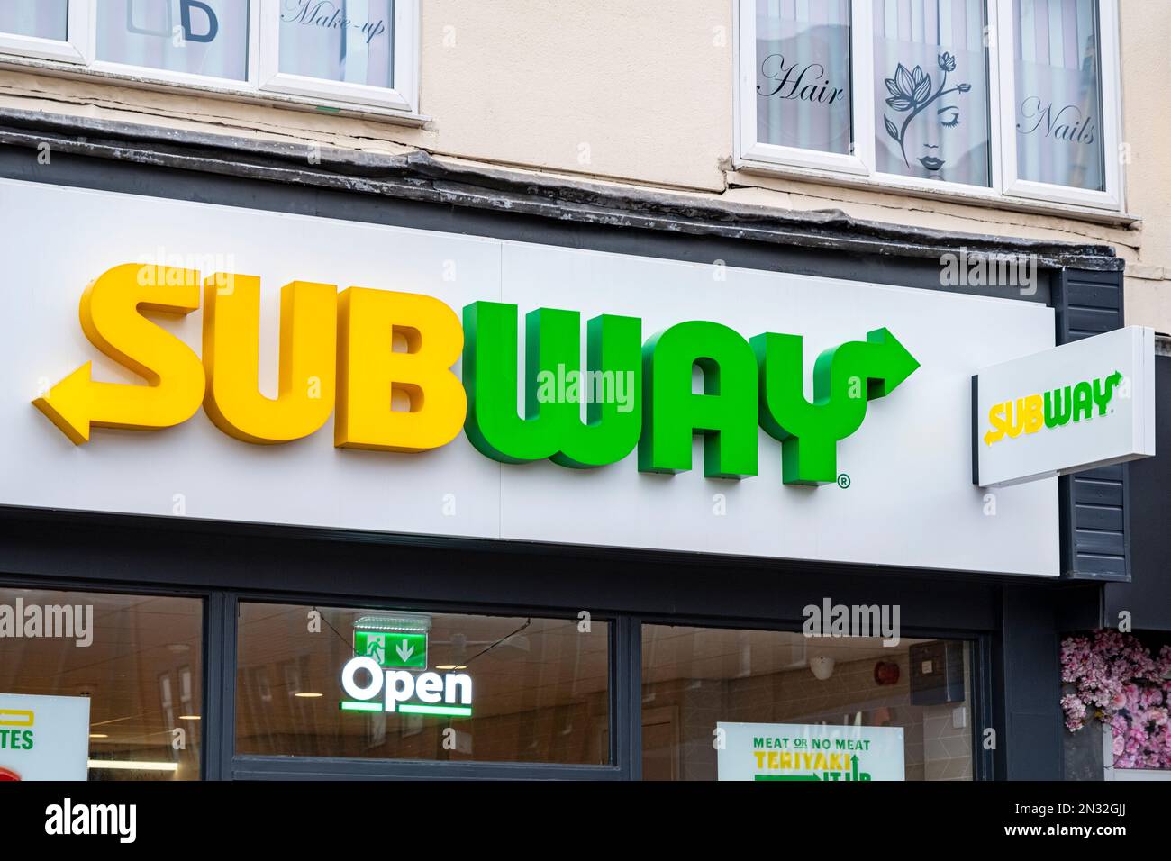 Close up of Subway sign with logo on outside wall UK Stock Photo