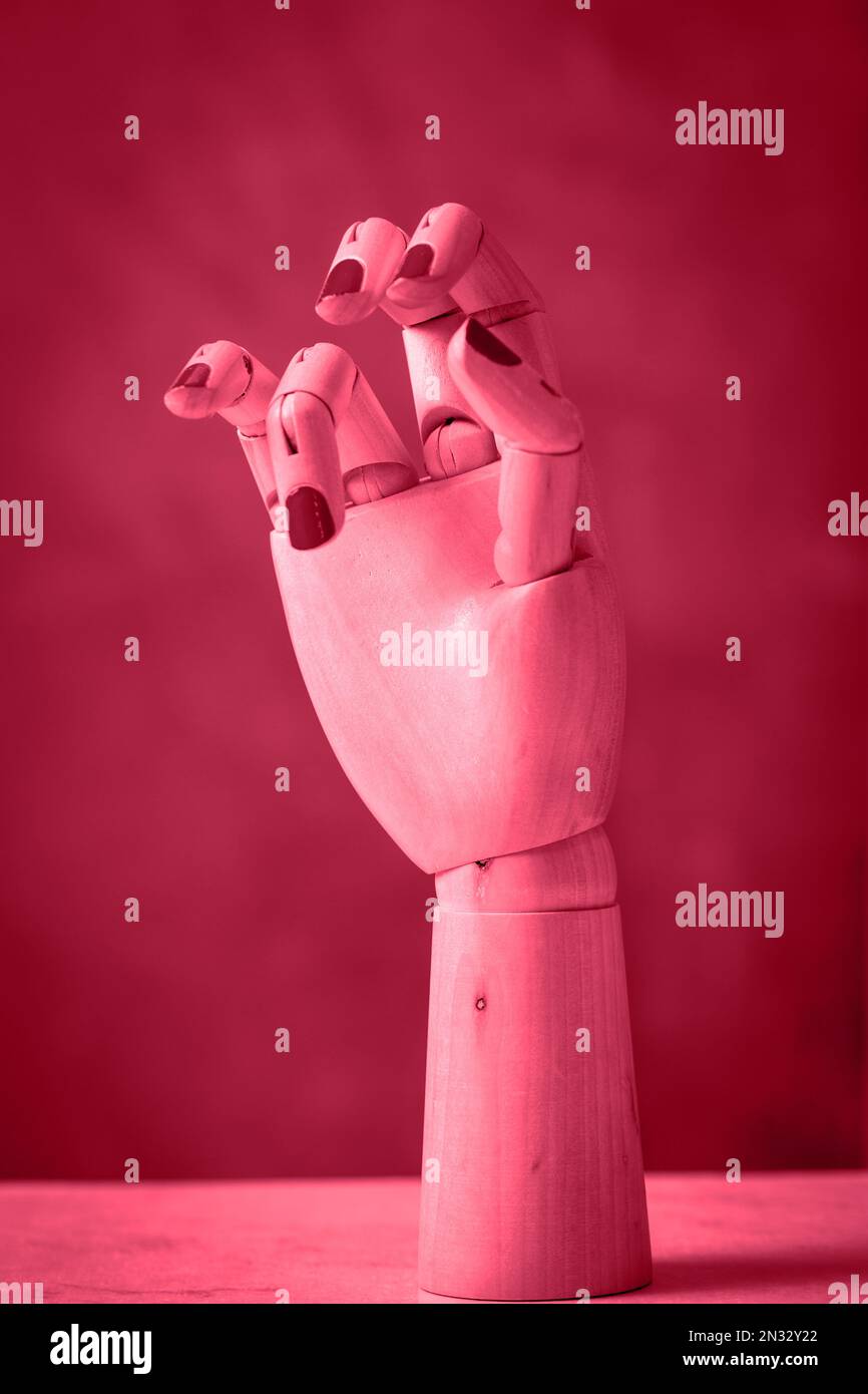 Mannequin hands made of wood on a pink background Stock Photo Alamy
