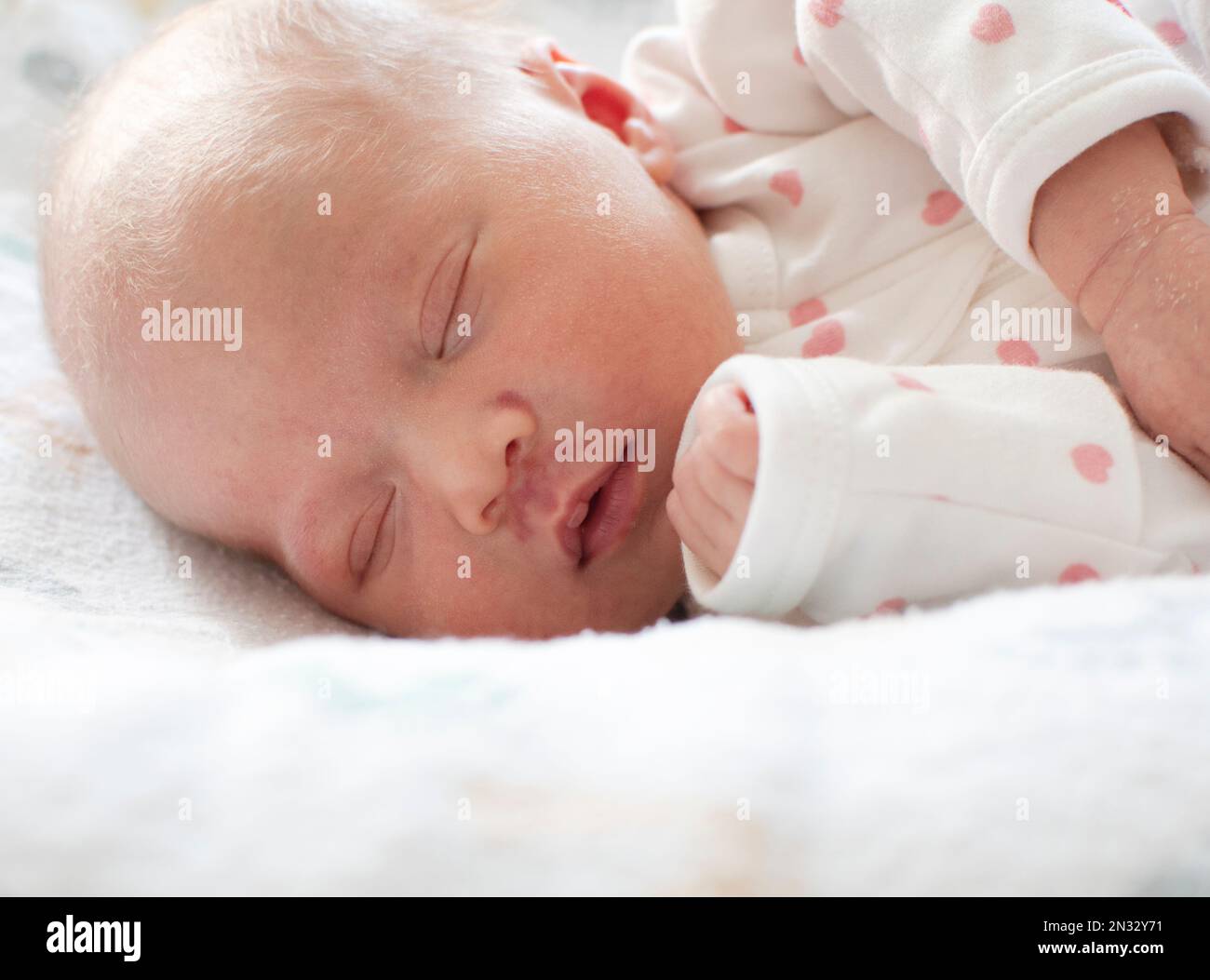 Sleeping white caucasian newborn baby closeup. Angel's kiss, stork bite ...