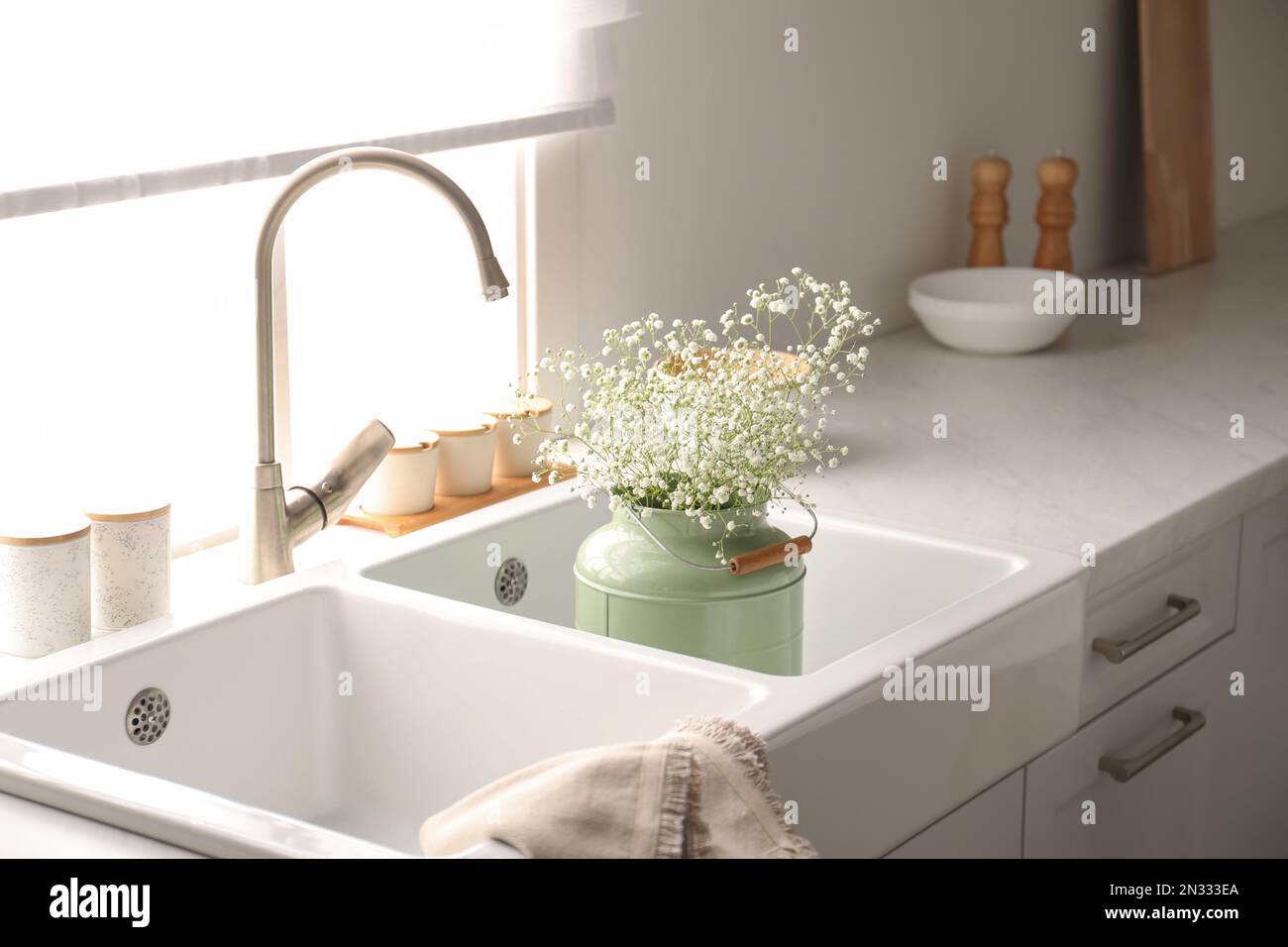 Bouquet of gypsophila flowers in sink. Kitchen interior design Stock