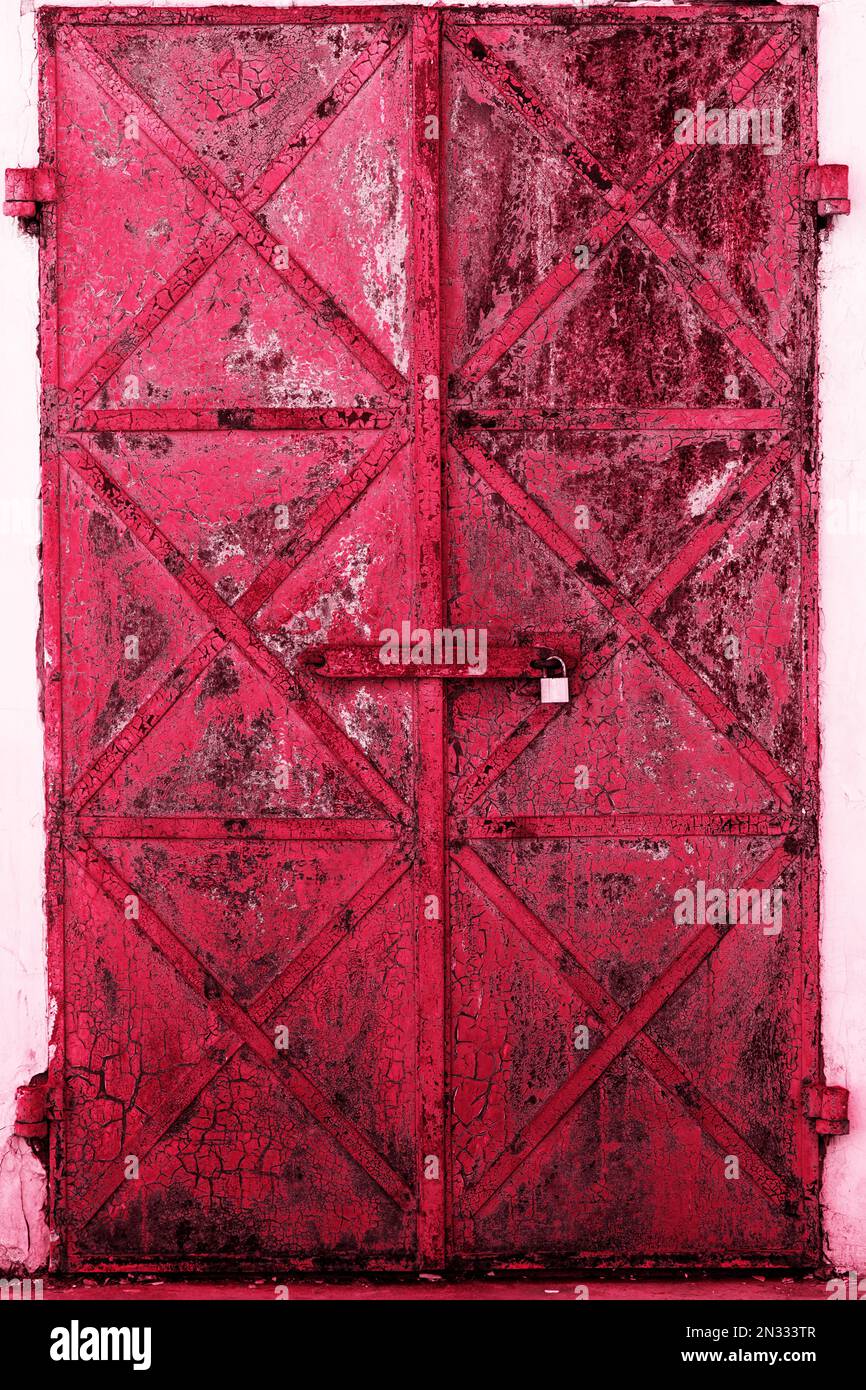 Old rusty, doors on a white wall Stock Photo